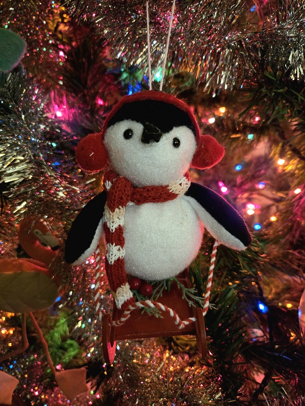 A Christmas ornament featuring a skiing penguin.